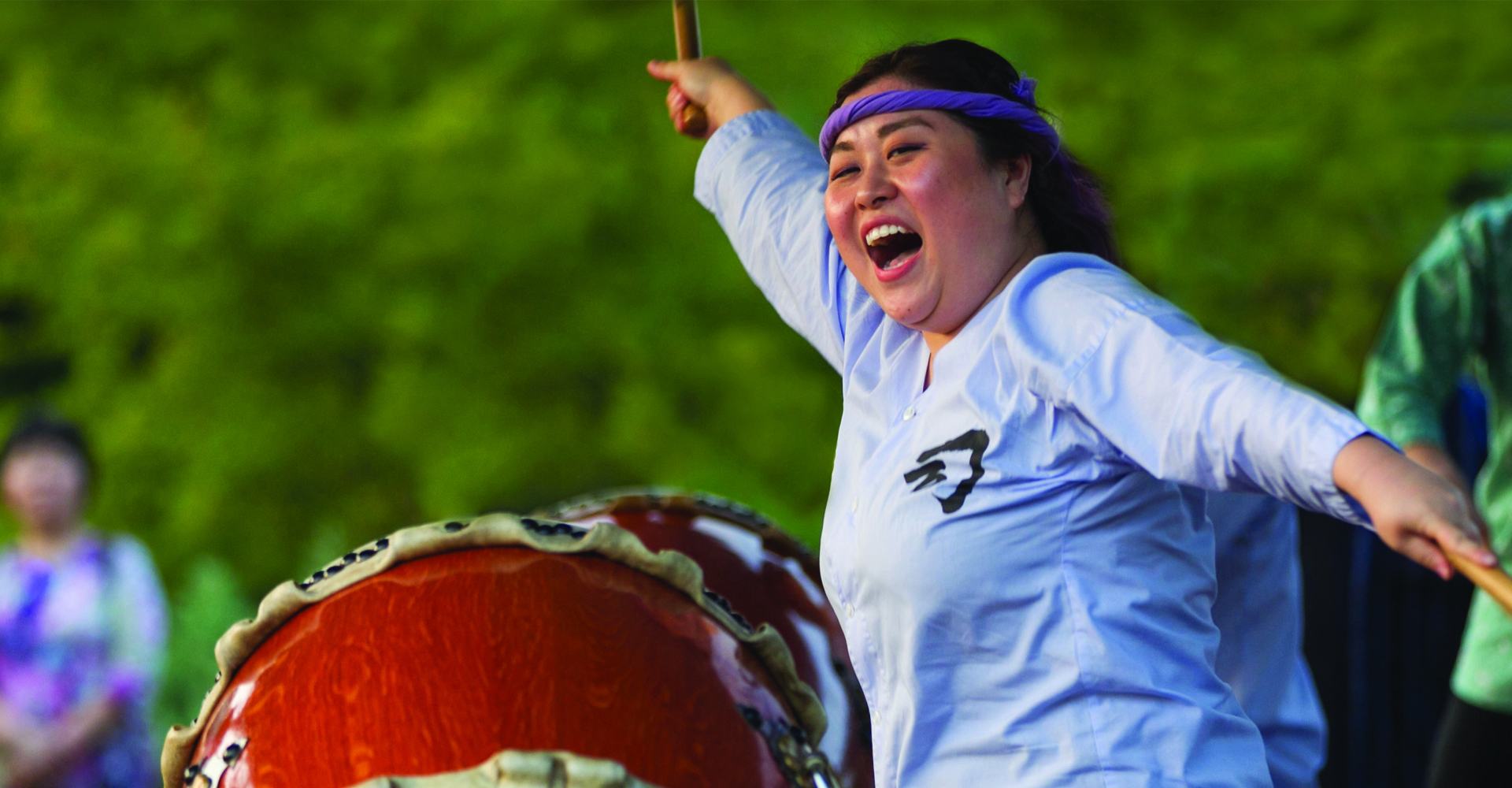 Woman plays a drum at the Destination Asia Festival