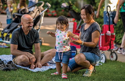 Family plays in the Children's Garden at an event in summer