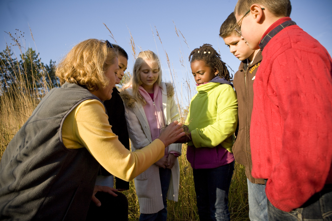 Teacher with students in the prairie