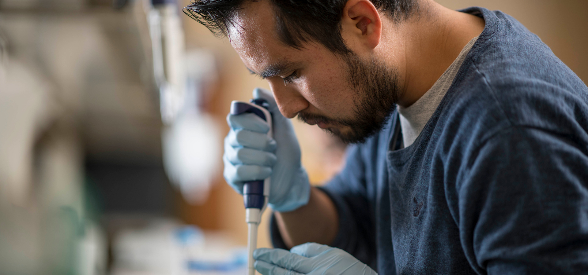 Researcher using a pipette