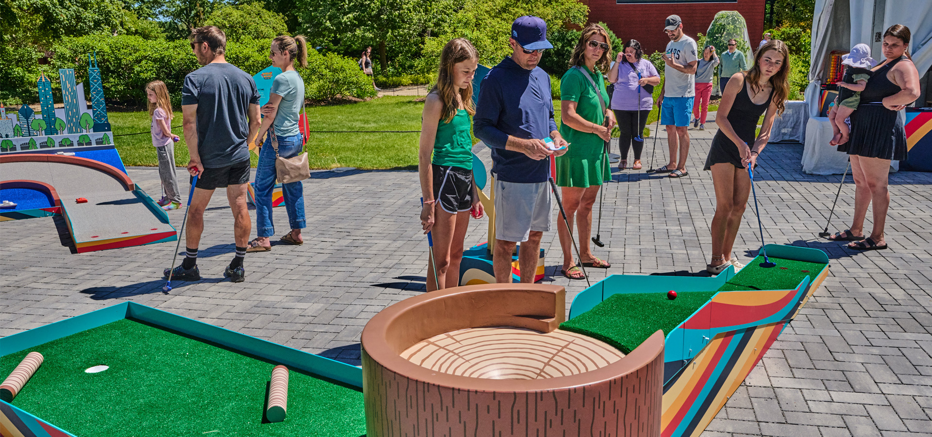 Photograph of families playing mini golf at Wonder Woods Mini Golf at The Morton Arboretum